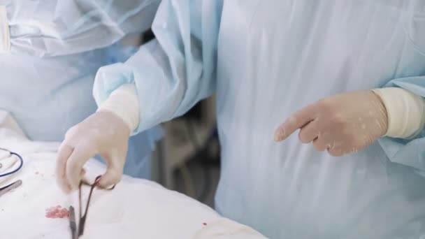 Close up assistant doctor hands  disinfects, cleans blood from medical instruments after surgery — Stock Video