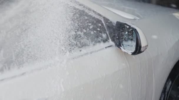 Car washing process. Spray foam covers machine and cleans it from dirt. Slow motion — Stock Video