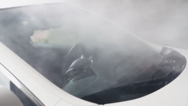 Car washing. Jet of water with high pressure clean off windshield of car. Slow motion — Stock Video