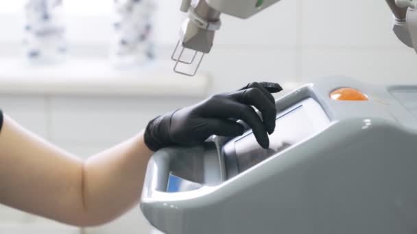 Close up medical equipment. Beautician hand turn on electronic device, slow motion — Stock Video