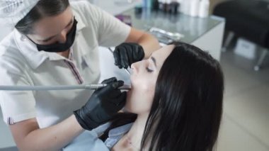 Dişçi genç kadına diş, yavaş çekim. Diş tedavisi kavramı