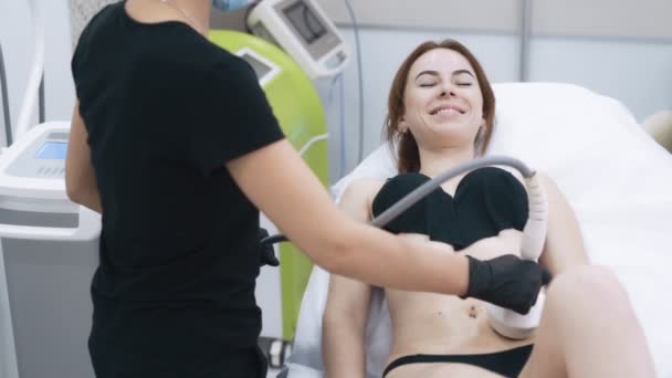Jonge vrouw in het kantoor van cosmetoloog doet anti-cellulitis therapie, slow motion — Stockvideo