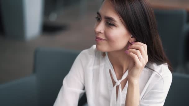 Portrait of beautiful smiling brunette girl, touches earring, laughs, slow motion — Stock Video