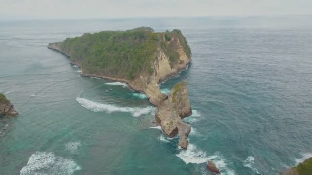 Luchtfoto van eiland, kliffen, blauw water van de Oceaan en golven, Bali, Indonesië — Stockvideo