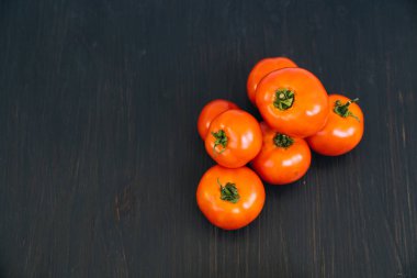 Kopya alanı ile siyah ahşap arka plan üzerinde kırmızı kiraz domates üst görünümü