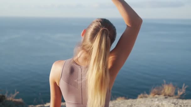 Baksidan syn på kvinnan praxis yoga på mattan, mediterar på morgonen, slow motion — Stockvideo