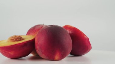 Beyaz arkaplanda izole edilmiş nektarin ve şeftali döndürme tablosunu kapat