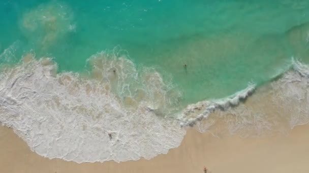 Vue aérienne de la plage de sable blanc avec les touristes et l'eau bleu azur, les vagues de l'océan 