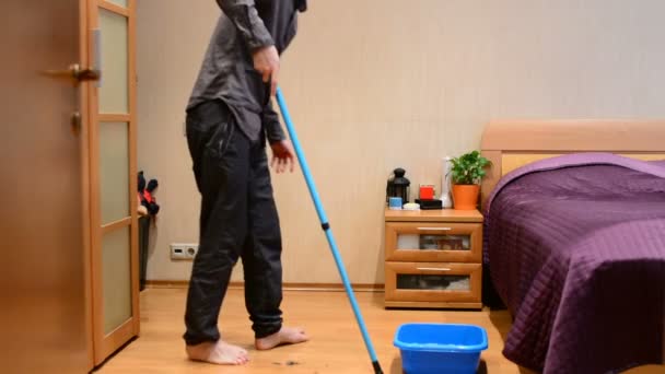 Young Man Washes Mop Floors — Stock Video