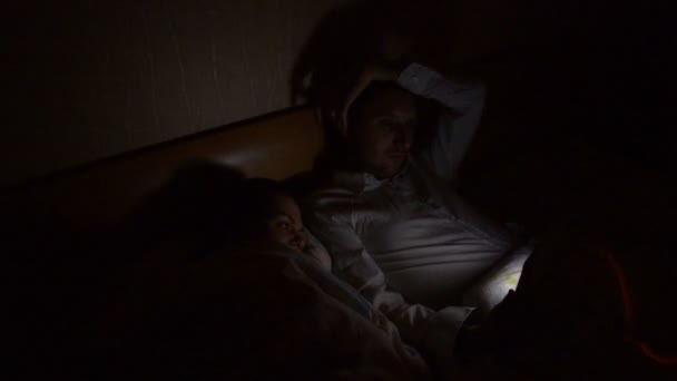 Young Couple Smartphone Tablet Lying Bed Late Night Home — Stock Video