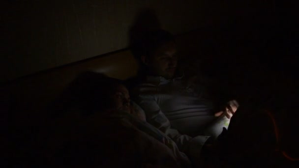 Jong Stel Met Smartphone Tablet Ligt Avonds Laat Thuis Bed — Stockvideo