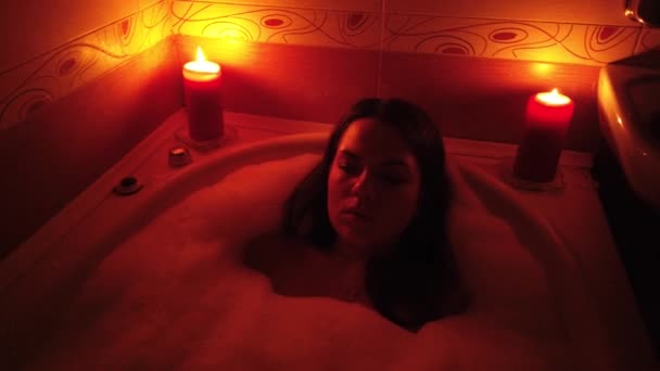 Attractive Young Woman Taking Bubble Bath Burning Candles — Stock Video