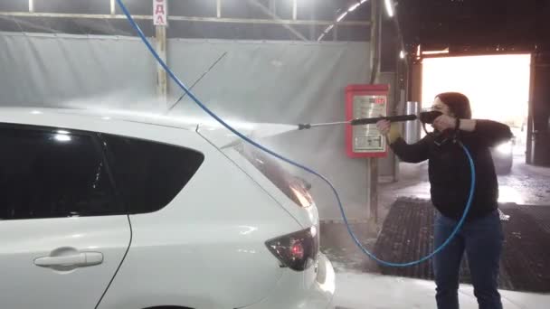 ロシア モスクワ 2019 ブルネットの女の子は スプレーツールを使用し ウォッシュボックスで泡によって車をカバー — ストック動画