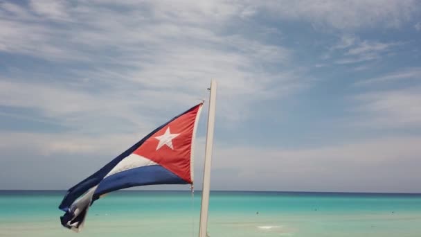 Cuban flag on the beach, flying in the wind on background of ocean. Cuba, Varadero.