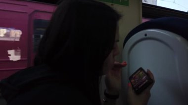 Trendeki kız ve bir akıllı telefon. Seyahat taşımacılığı demiryolu konsepti. Pencerede trende kız pencerede tren vagonundaki kıza karşılık gelir..