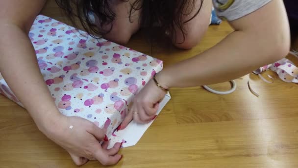 Girl Packs Fires Beautiful Multicolored Paper Ties Orange Bow — Stock Video