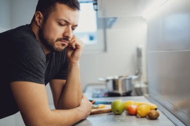 Mutfak Tezgah eğilerek ve düşünme kızgın adam
