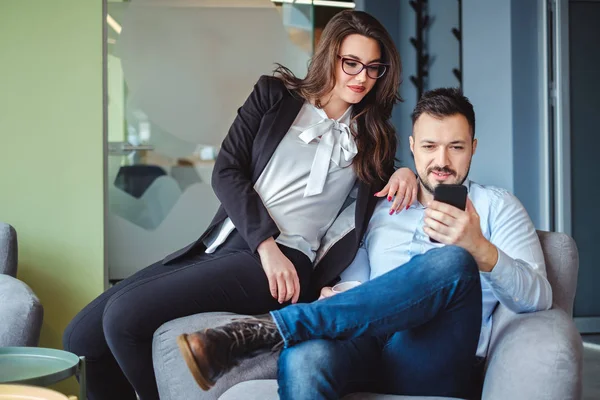 Colegas Femeninas Masculinas Mirando Teléfono Móvil Sonriendo Mientras Están Sentadas — Foto de Stock