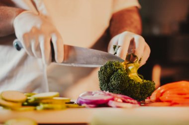 Eldivenler ve brokoli bir bıçak ile kesmek için başlangıç mutfak Şef