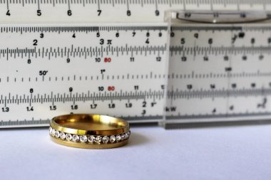 Gold ring with diamonds and a measuring instrument, the value of jewelry, object clipart