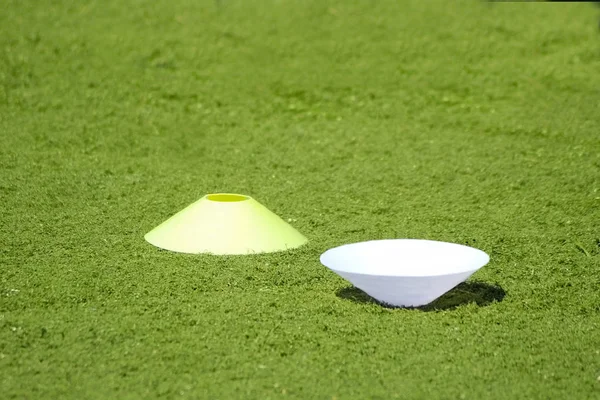 Plastic chips for football training. Sports playground with markings on an artificial lawn on a soccer field.