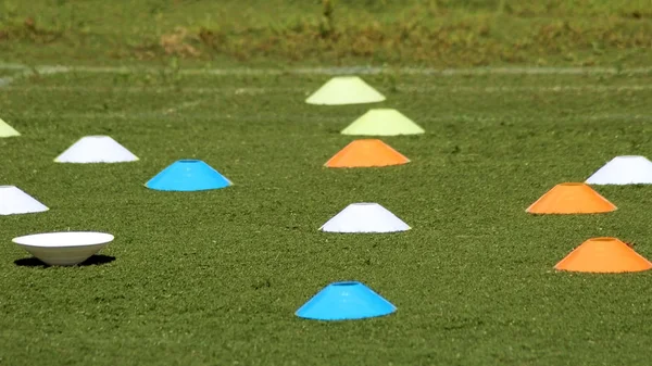 Plastic chips for football training. Sports playground with markings on an artificial lawn on a soccer field.