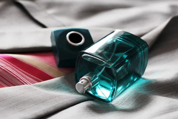 Men 's perfume in beautiful bottle on the grey jacket — стоковое фото