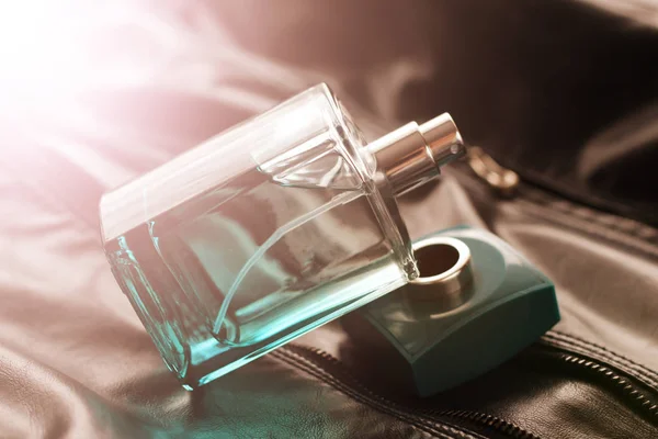 Men's green perfume in beautiful bottle on leather fabric — Stock Photo, Image