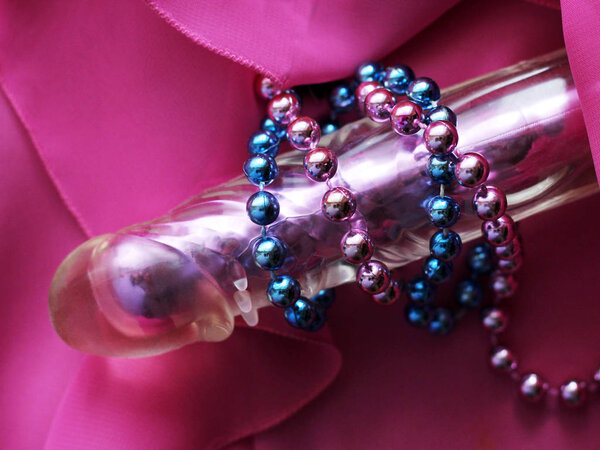 Female pink vibrator and beads. Sex toy for adults.