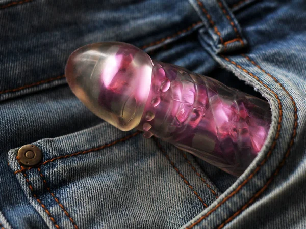 Female pink vibrator and jeans. Sex toy for adults. — Stock Photo, Image