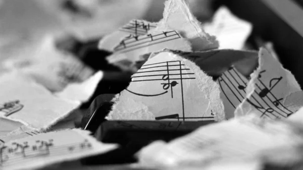 Notas musicales desgarradas, trozos de papel sobre piano — Foto de Stock
