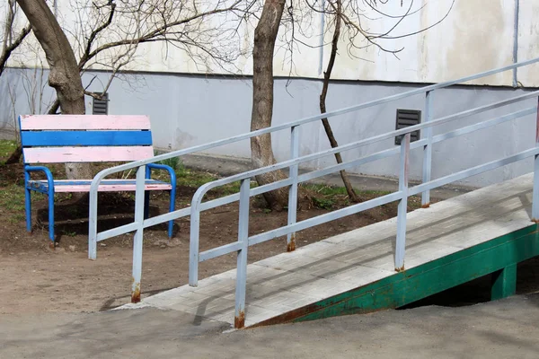 A wheelchair ramp, an inclined plane installed in addition to or instead of stairs.