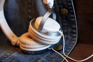 White big headphones and denim jacket
