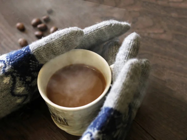 Чашка горячего кофе и перчатки — стоковое фото