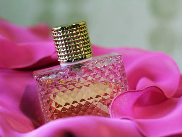 Glass bottles on pink dress — Stock Photo, Image