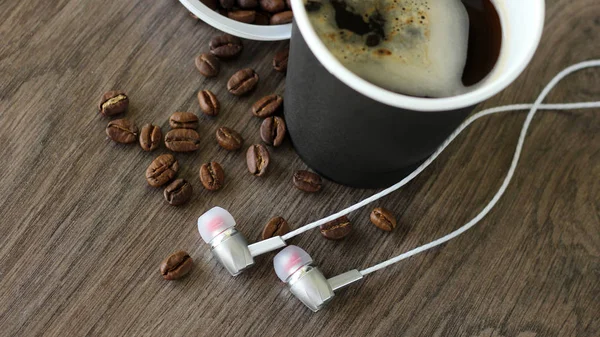 Coffee cup and headphones so close, top view — Stock Photo, Image