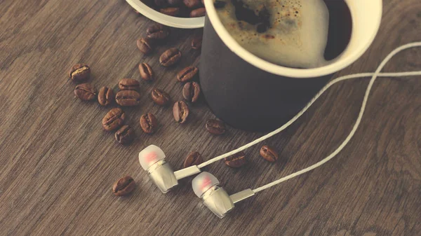 Coffee cup and headphones so close, vintage top view — Stock Photo, Image