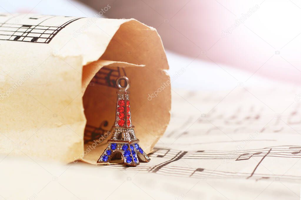 Small bronze of Eiffel tower figurine and music paper so close