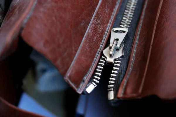 Zipper lock on brown leather bag