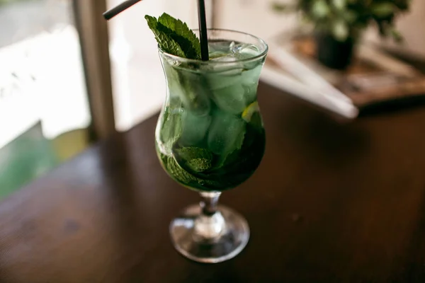 Mojito Cocktail Non-alcoholic cocktail in glass groceries. On a wooden table.