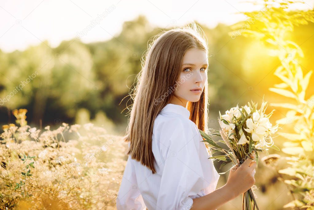 beautiful girl with flowers in nature