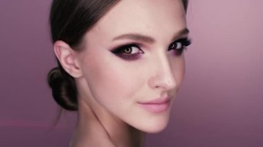 güzel bir kız makyaj ve çiçekler güzellik portresi. Studio pembe bir arka plan üzerinde makro çekim