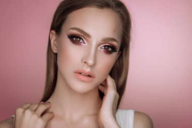 makyaj ve saç kesimi pembe bir arka plan üzerinde Studio ile güzel bir zarif esmer kız portresi