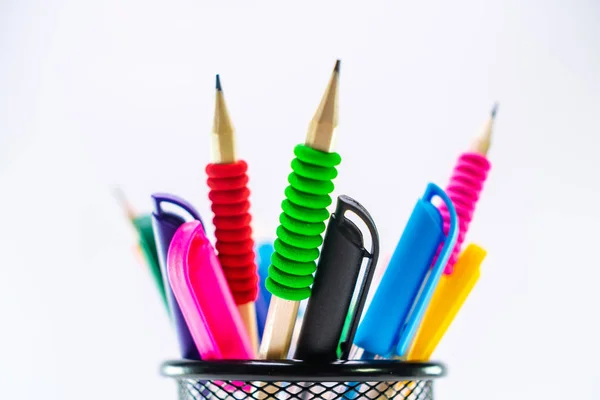 Colored pencils in a pencil case on white background