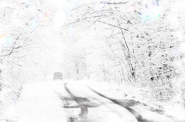 Car and winter road in snowfall forest. Fairy forest covered with snow. Rural road  with car at dark night time