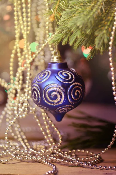 Christmas tree branch  and  blue ornament. Blue ball on Christmas tree