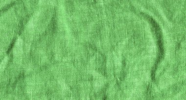 Arka plan için yeşil kumaş yüzeyi. Yeşil keten doku. Değişik kullanım amaclı arka planı yeşil  