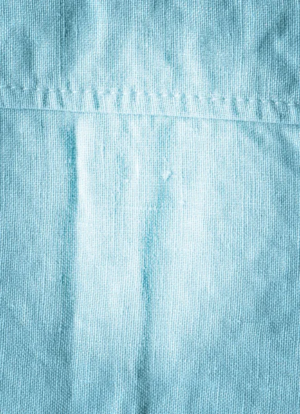 Turquoise fabric background texture. Turquoise background from a textile material