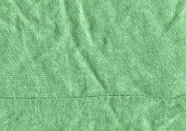 Arka plan için yeşil kumaş yüzeyi. Yeşil keten doku. Değişik kullanım amaclı arka planı yeşil  