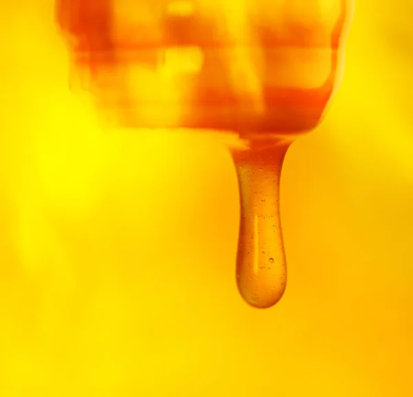 Melted caramel dripping.  Pouring  stream of caramel sauce